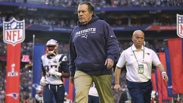 Bill Belichick walks onto the field before Super Bowl XLIX